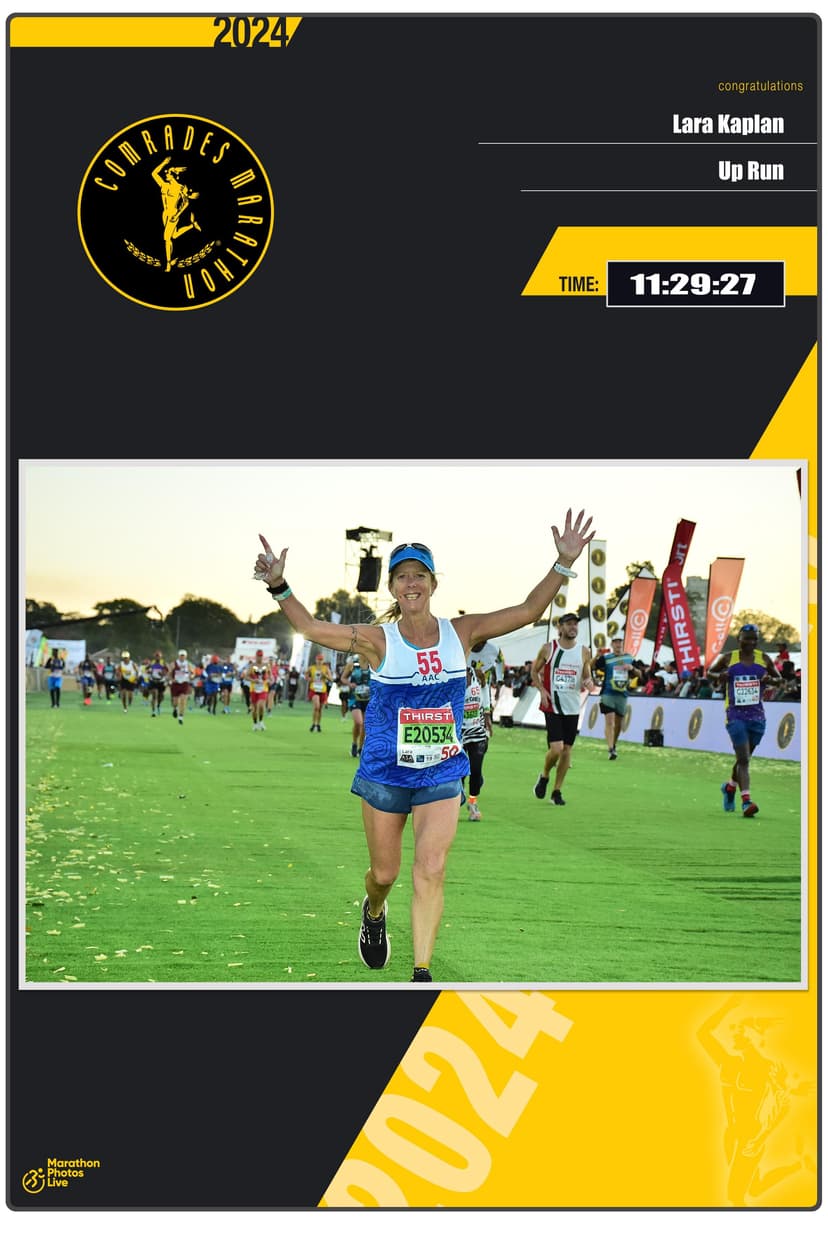 Lara Kaplan crossing the Comrades Marathon finish line with arms raised at kilometer 89